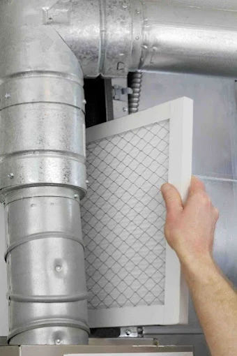 HVAC filter replacement during heating maintenance service
