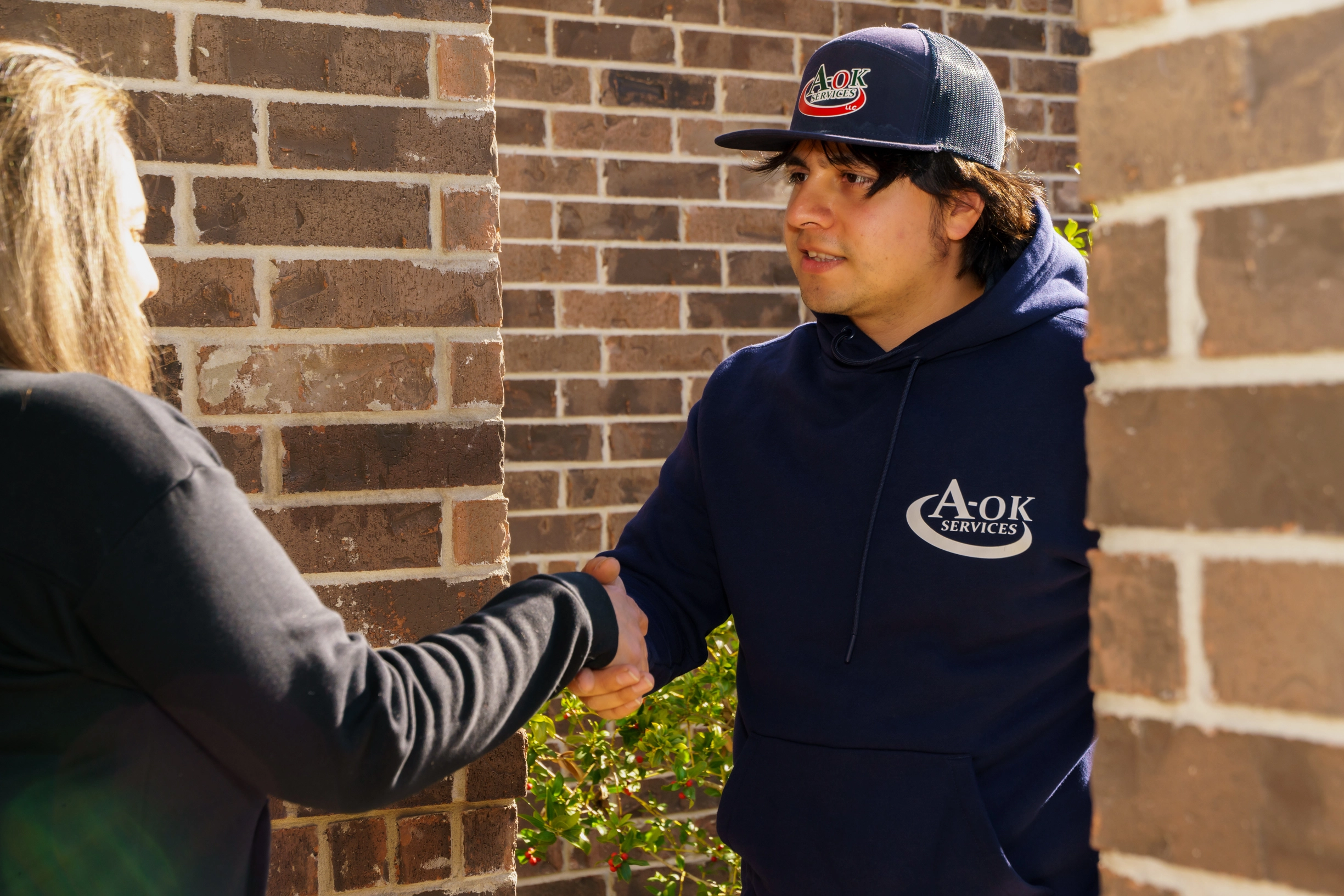 A-OK Services thermostat technician greeting customer for service appointment